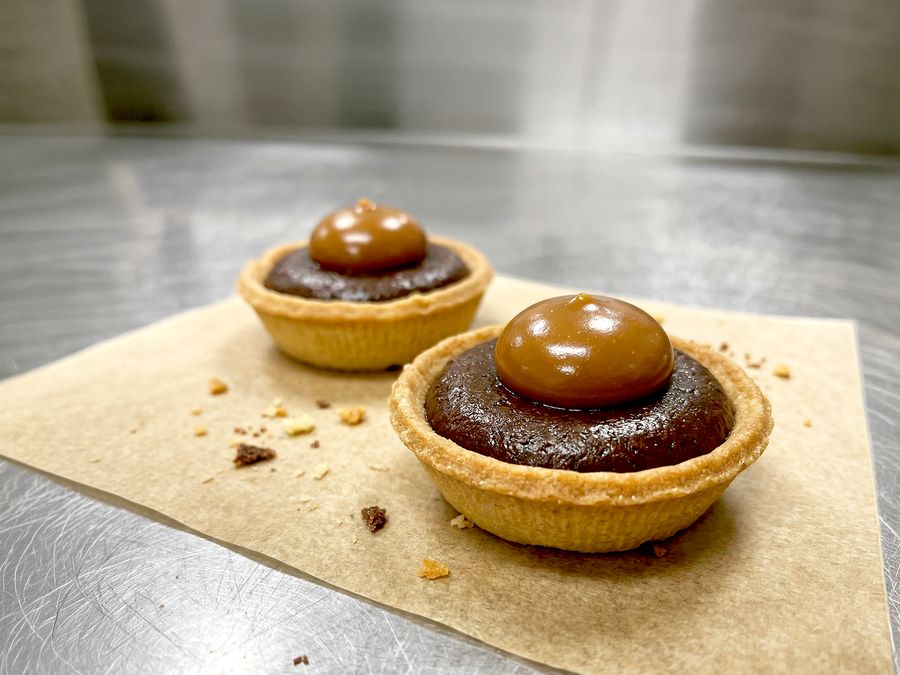 Mini chocolate tarts topped with a dome of salted caramel