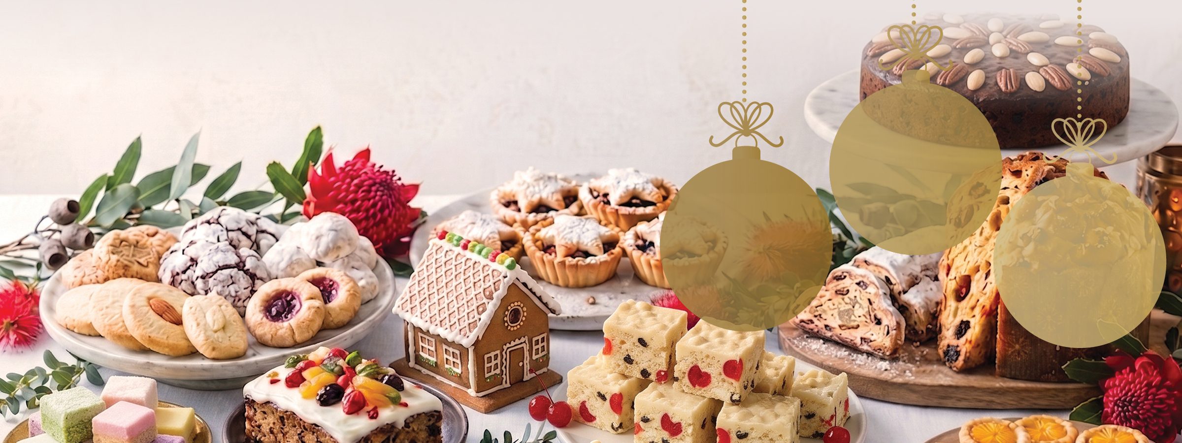 Festive bakes including gingerbread house, mince tarts, white Christmas slice, stollen and panettone, with three gold baubles: Traditional Christmas, classics that make Christmas magical; Global Celebrations, a world of festive inspiration; Festive Showstoppers, eye-catching sweet and savoury treats.